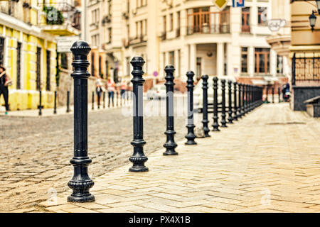 Small street with cobblestone pavement in historic center of European city, cobbles, modern city Stock Photo