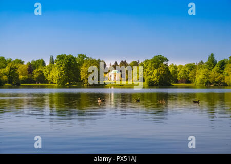 Great panoramic view of Swan Island (Schwaneninsel) with its small white temple and ducks swimming on the lake (Aueteich) on a nice sunny day in the... Stock Photo