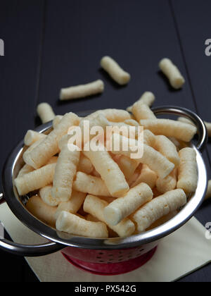 Puffelets Snack Crunchy corn puffs, pufuleti in white bowl Stock Photo - Alamy