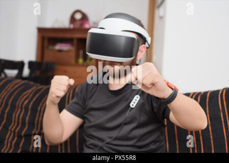 Bearded man wearing virtual reality goggles Stock Photo