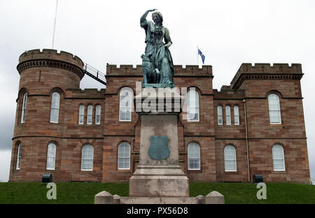 A statue of Flora MacDonald sits outside Inverness Castle and overlooks the city from there. She helped Bonnie Prince Charlie flee Scotland after his defeat at the Battle of Culloden in 1746. Stock Photo