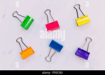 Colorful foldback paperclips stationery on white background Stock Photo