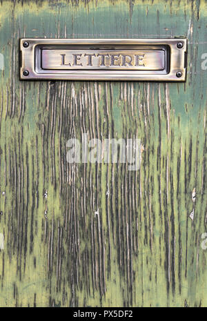 Old Italian mailslot with message 'Lettere' (Letters), on old wood door. Stock Photo