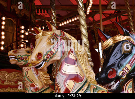Horses on a fairground carousel Stock Photo