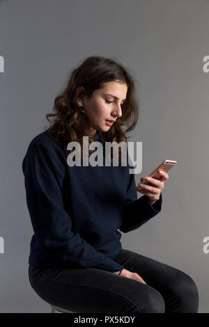 Young woman using a cell phone. Paris, France. Stock Photo