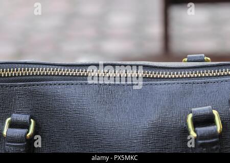 Close up zipper of black leather bag Stock Photo