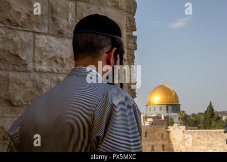 Orthodox jew looking at the Western wall and Dome of the Rock, Jerusalem. Israel. Stock Photo
