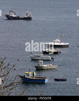 A few small boats are moored in the bay at Portree, which is the capital town on the isle of Skye in Scotland. Stock Photo