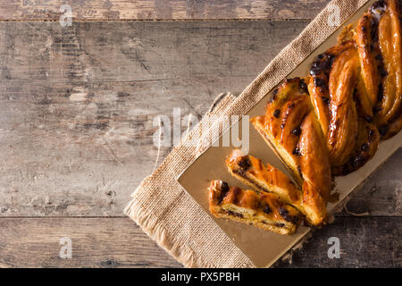 Homemade braid chocolate on wooden table. Top view. Copyspace Stock Photo