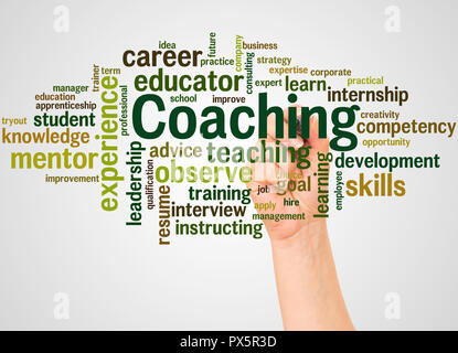 Coaching word cloud and hand with marker concept on white background. Stock Photo