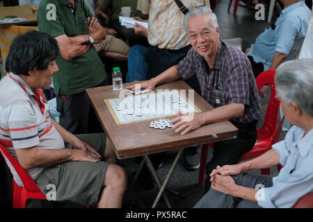 Ethnic Chinese citizens are playing Chinese versions of chess at Telok Ayer Square, Chinatown, Singapore Stock Photo