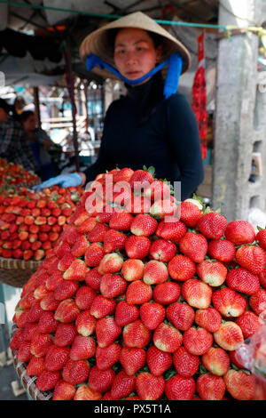 Vietnamese woman selling fresh strawberries at street market.   Dalat. Vietnam. Stock Photo