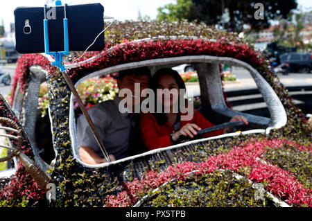 Young vietnamese couple taking self portrait in car.  Dalat. Vietnam. Stock Photo