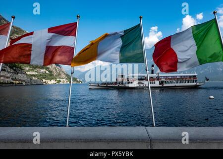 Italy, Garda-Lake, Limone, 09.05.2018. historic paddle steamer Italia approaching the village of Limone with flags of Denmark, Ireland and Italy in fo Stock Photo