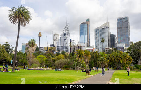 Tourists taking photographs in Royal Botanical Garden and office towers and skyscrapers of CBD Sydney NSW Australia. Stock Photo