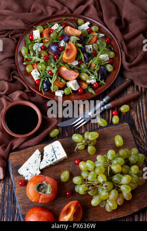 Blue cheese with mold served salad leaves on wood background Stock ...