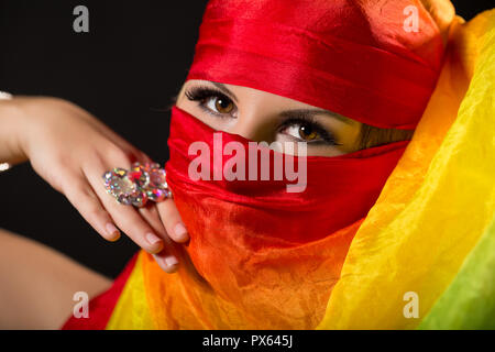 Close up portrait of belly dancer wrapped in veil. Stock Photo