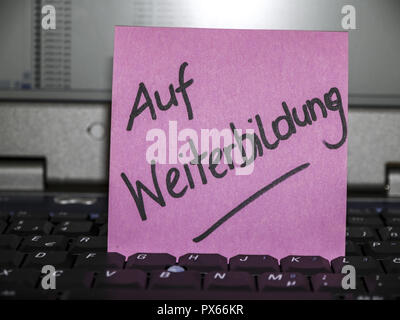 Memo note on notebook, on further education, training Stock Photo