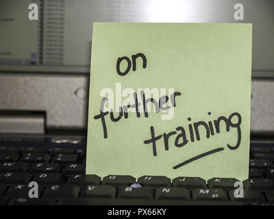 Memo note on notebook, on further training Stock Photo