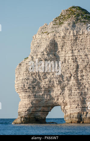 Natural stone arch on chalk cliffs with the sea in Etretat, Normandy, France Stock Photo