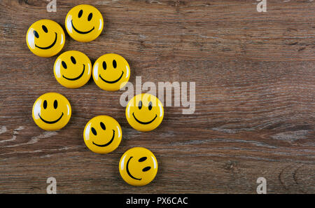 emoticon icons on wooden background top view Stock Photo