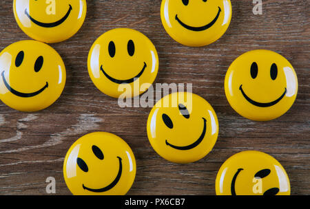 emoticon icons on wooden background top view Stock Photo