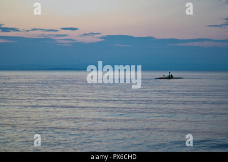 canoeist at the lake during sunset Stock Photo