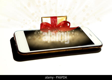 Gold present box magically coming out from the isolated smartphone - Concept of e-commerce sales, online shopping, digital marketing at christmas time Stock Photo