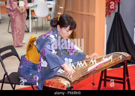 Sep 26, 2018: A japnese girl wering tradional Hanbok Dress playing tradional Koto instrument, Abu Dhabi, UAE Stock Photo