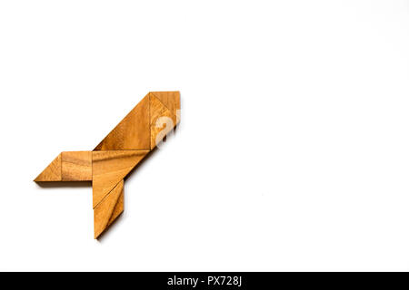 Wooden tangram puzzle in rocket shape on white background (Concept for new experience, start project) Stock Photo