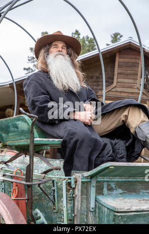 Western man  in traditional clothing sitting on a wagen Stock Photo