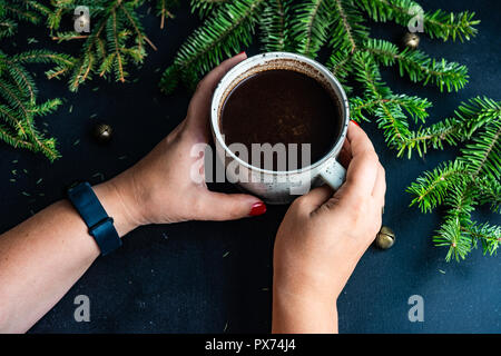 Cup of coffee on dark wooden background with holiday decor and copy space Stock Photo