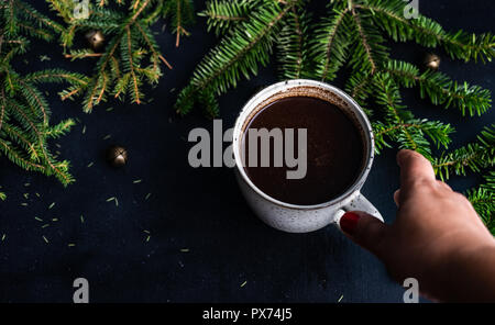 Cup of coffee on dark wooden background with holiday decor and copy space Stock Photo