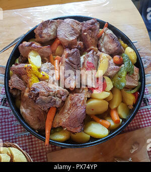 Cooking of traditional Croatian meal Peka in metal pots called sac ...