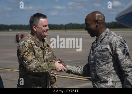 U.S. Air Force Lt. Gen. Brad Webb, left, commander of Air Force Special Operations Command, greets Chief Master Sgt. of the Air Force Kaleth O, October 14, 2018. Wright at Hurlburt Field, Florida, Oct. 14, 2018. Aircrew members with the 8th Special Operations Squadron transported Air Force senior leaders from Hurlburt Field to Tyndall Air Force Base to assess the damage from Hurricane Michael, one of the most intense tropical cyclones to ever hit the U.S. (U.S. Air Force photo by Senior Airman Joseph Pick). () Stock Photo