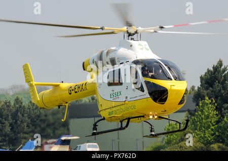 Essex and Herts Air Ambulance landing at Earls Colne. G-EHAA. MD900 Explorer helicopter, medical emergency response. Specialist Aviation Services Stock Photo