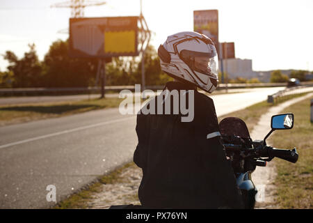 Half-turned biker on his motorcycle Stock Photo