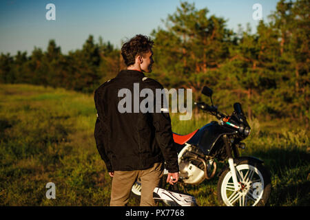 Back of a biker in black leather jacket Stock Photo