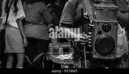 The visually impaired sing for money at the market in Thailand. Blind people begged for donation. Nobody is interested in the visually impaired. Disab Stock Photo