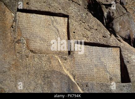 Ganjnameh. Ancient inscription carved in granite in Alvand Mountain, ordered by Darius the Great (521-485 BC) (left) and by Xerxes the Great (485-465 BC) (right) in three languages, Old Persian, Neo-Babylonian and Neo-Elamite. Near Hamedan. Islamic Republic of Iran. Stock Photo