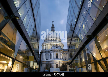 This is a picture of St. Pauls Cathedral in London.  It was taken in the evening with the churches reflections off of the buildings Stock Photo