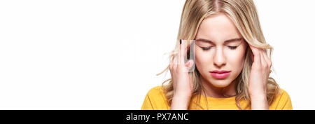 Young Woman Having Headache. Stressed Exhausted Young Woman massaging her temples. Woman Suffering From Migraine, Feeling Pressure And Stress banner. Stock Photo
