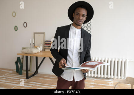 African american male in a hat standing with a book. Stock Photo