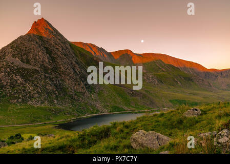 Moonset and sunrise. Stock Photo