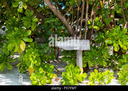 View of the wooden plate on the sandy beach, Maldives. With selective focus Stock Photo