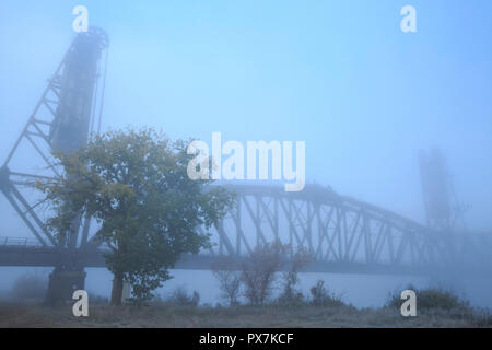 old snowden railroad bridge in fog over the missouri river near nohly, montana Stock Photo