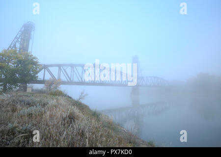 old snowden railroad bridge in fog over the missouri river near nohly, montana Stock Photo