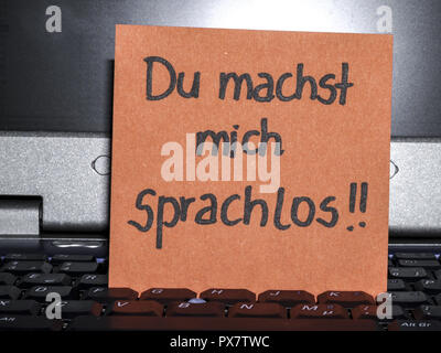 Memo note on notebook, Du machst mich sprachlos, you make me speechless Stock Photo