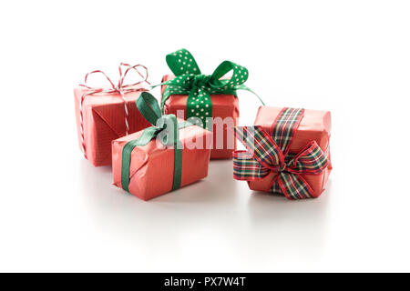 Gift boxes decorated with winter seasonal ribbons, on white background. Stock Photo