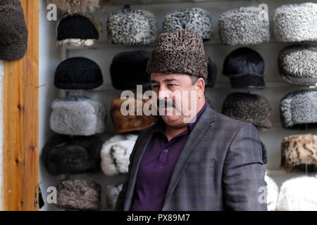 An Uzbek man wearing a Karakul or qaraqul hat traditionally made from the wool of the karakul sheep in the city of Bukhara in Uzbekistan Stock Photo